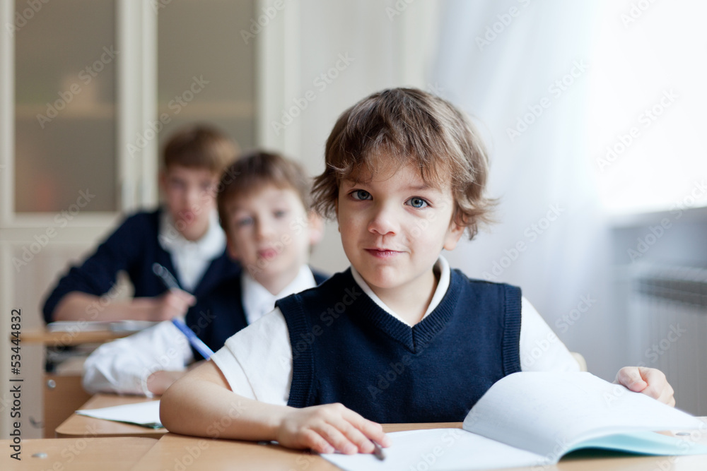 Diligent student sitting at desk, classroom Diligent student sitting at desk, classroom