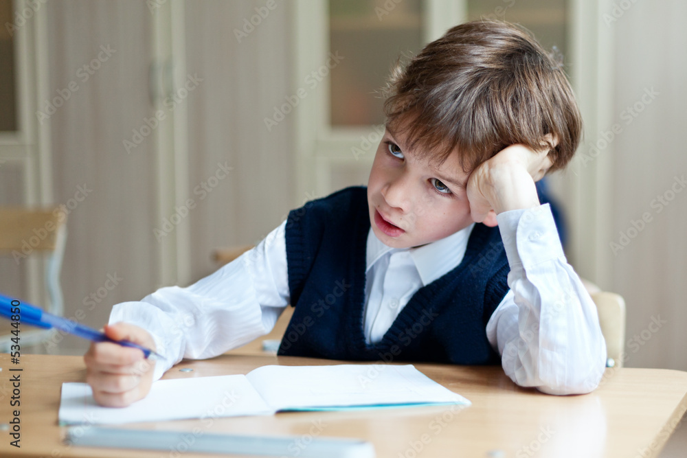 Diligent student sitting at desk, classroom Diligent student sitting at desk, classroom