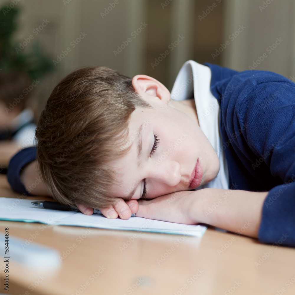 Diligent student sitting at desk, classroom Diligent student sitting at desk, classroom