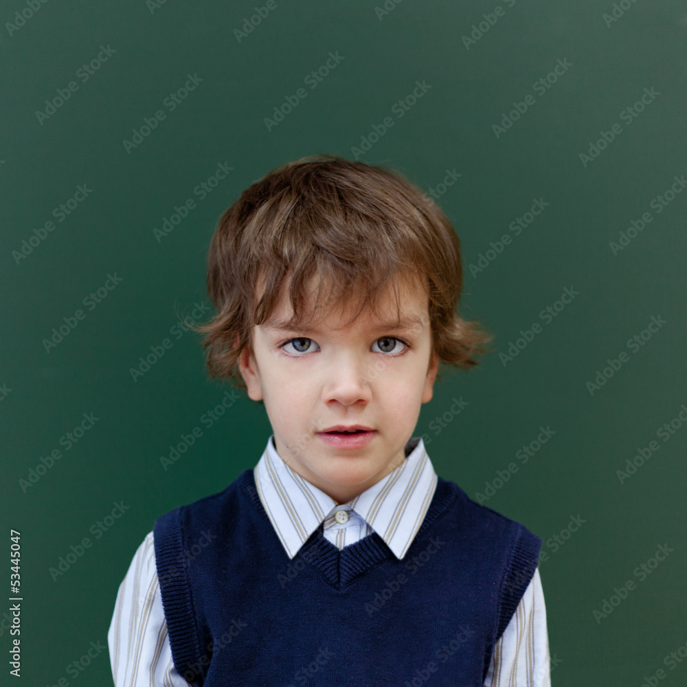 Portrait of student at blackboard background Portrait of student at blackboard background