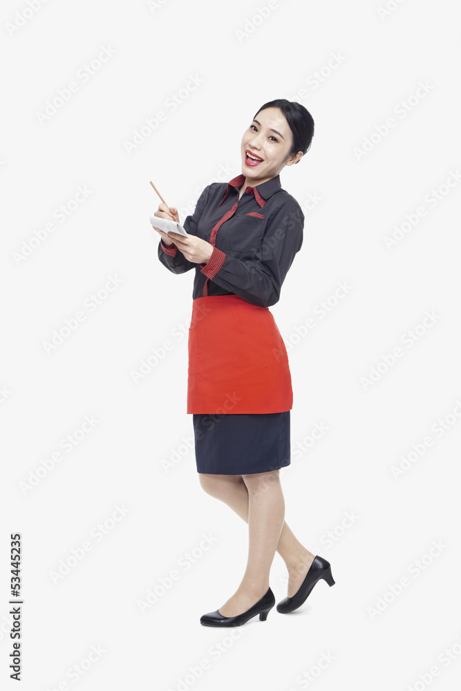 Young waitress taking an order, studio shot Young waitress taking an order, studio shot
