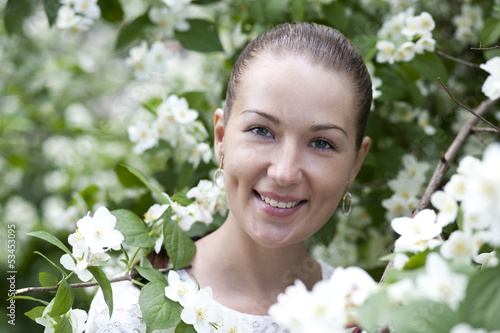 Portrait of beautiful brunette in spring blossom