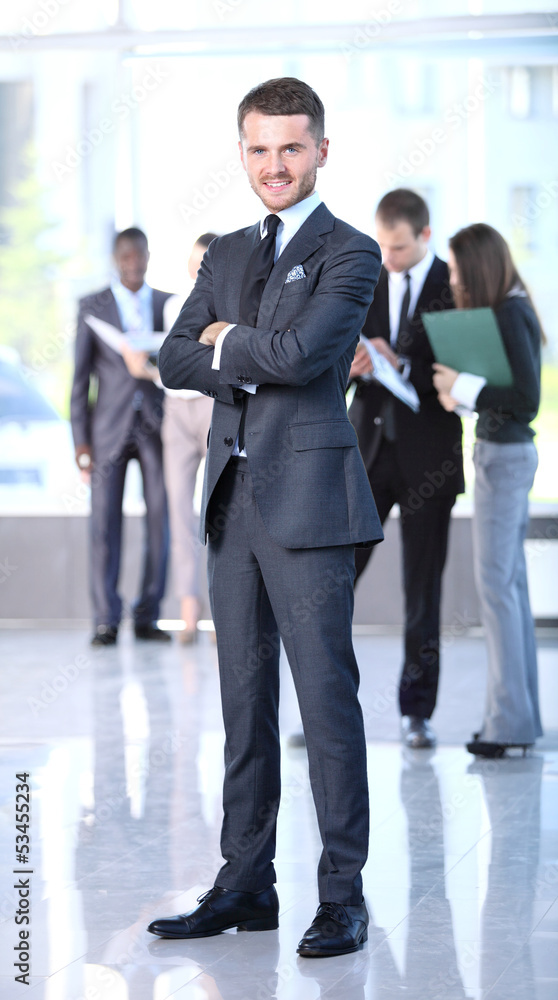 Happy smart business man with team mates discussing Happy smart business man with team mates discussing
