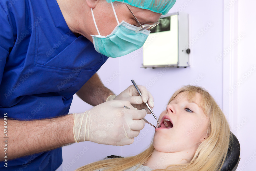 Dental-Surgeon examining the teeth of a woman. Dental-Surgeon examining the teeth of a woman.