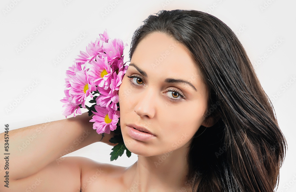 Portrait of young woman with flower