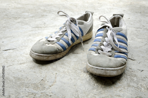 Old Running Shoes with concrete floor