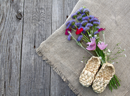 Rustic still life with a bouquet of blue flowers and decorative photo