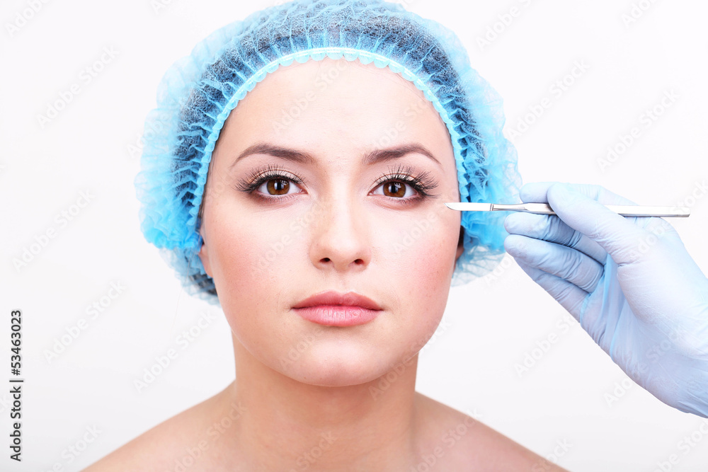 Cosmetic surgery with scalpel on young woman close up Cosmetic surgery with scalpel on young woman close up