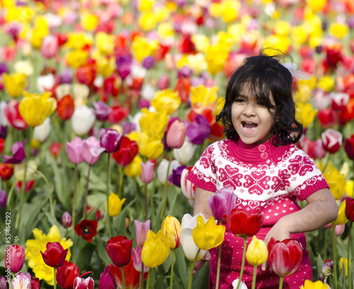 Little Girl Playing in Tulip Field