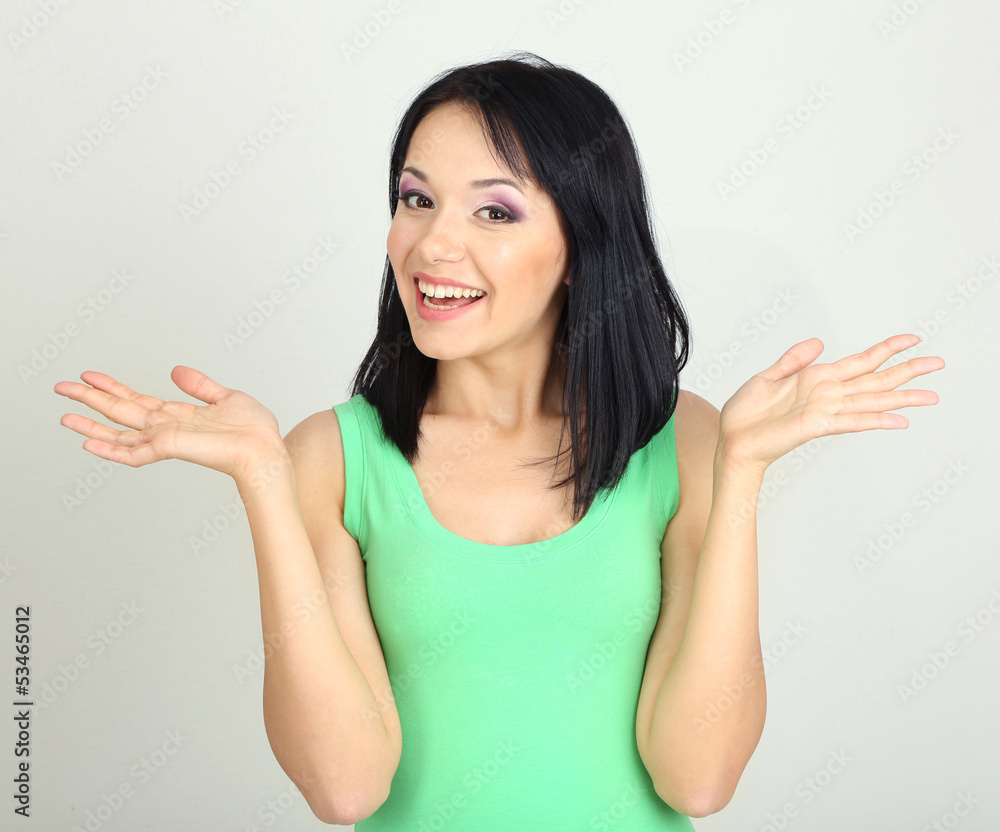 Beautiful girl smiling on grey background Beautiful girl smiling on grey background