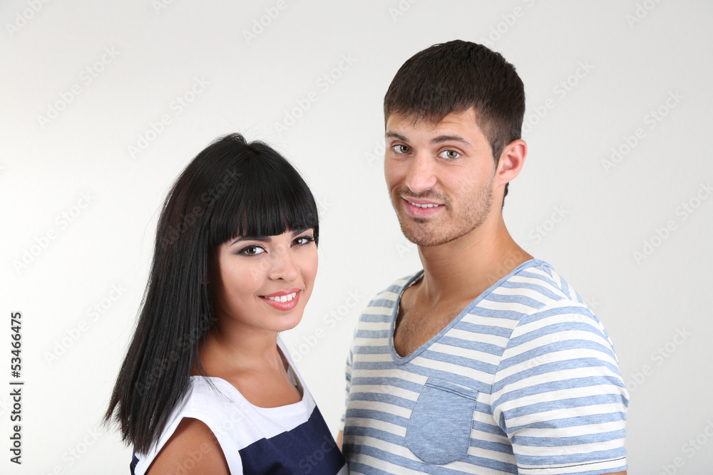 Beautiful loving couple together on grey background Beautiful loving couple together on grey background