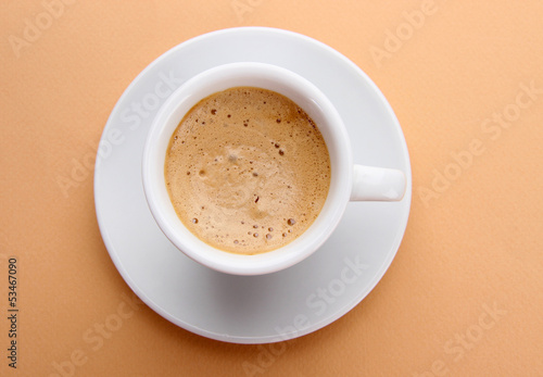 Cup of coffee on beige background