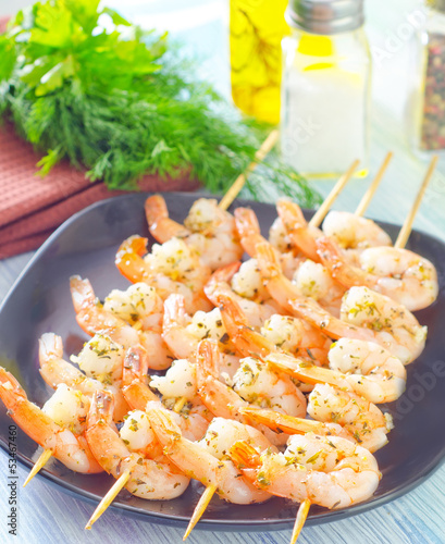 boiled shrimps are beaded on sticks