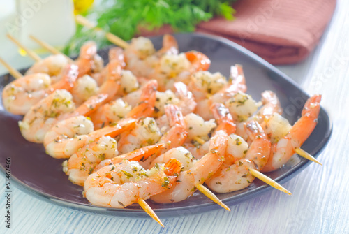 boiled shrimps are beaded on sticks