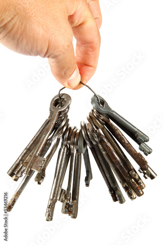 Bunch of old keys in hand isolated on a white background.