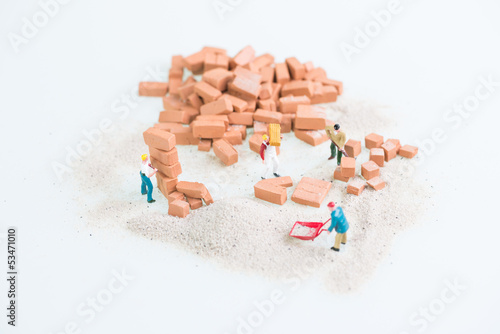 Miniature workmen doing consruction work top view photo