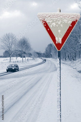 Onset of winter with road sign photo