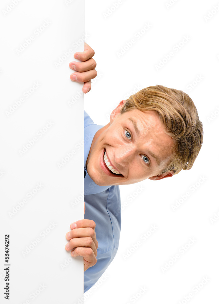 Confident young businessman looking over banner isolated on whi Confident young businessman looking over banner isolated on whi