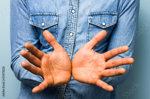 Blue collar worker showing his palms