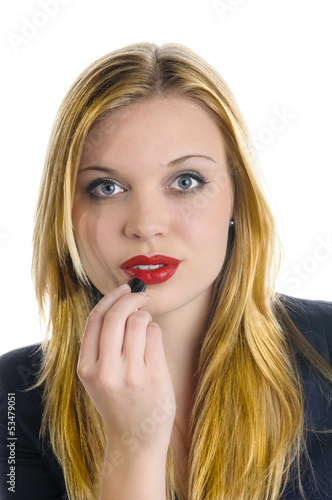 Young girl applying red lipstick