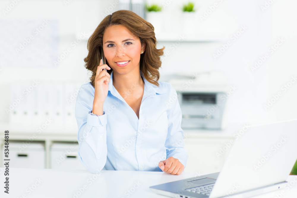 businesswoman with her cell phone in the office