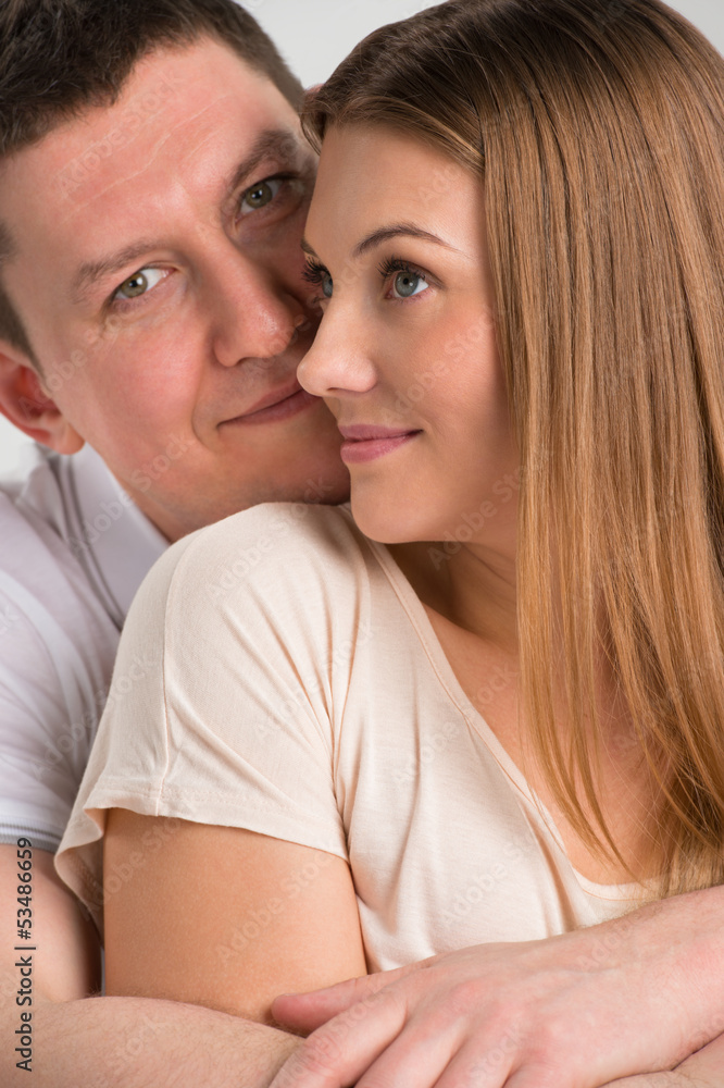 Portrait of a beautiful young happy smiling couple embracing