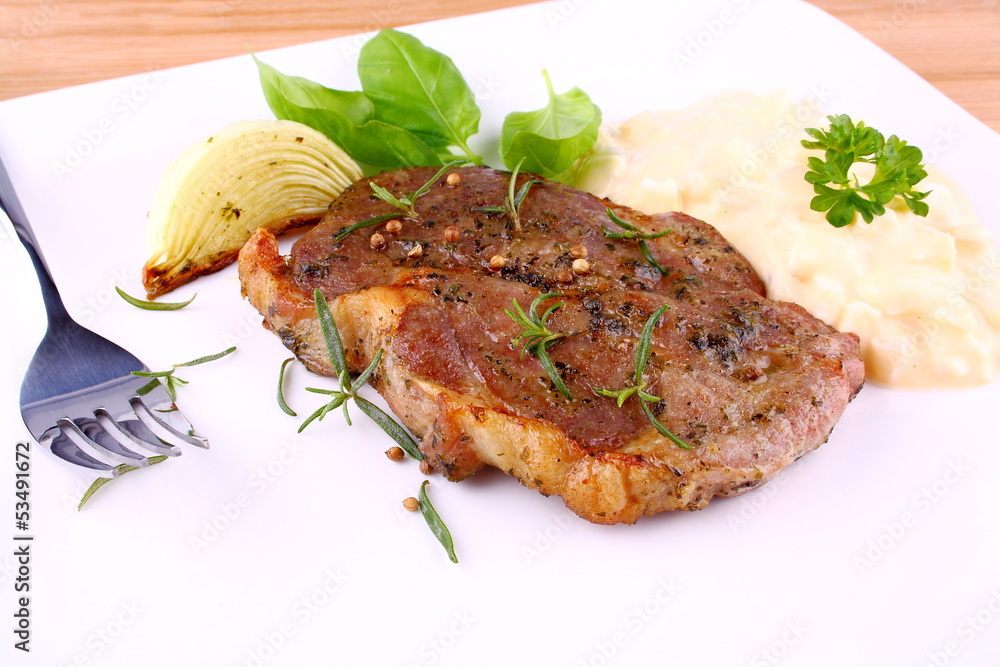 Herb Grilled steak meat with onion, potato salad Herb Grilled steak meat with onion, potato salad