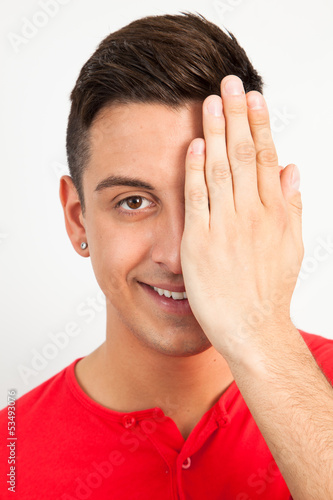 Young man covering one eye