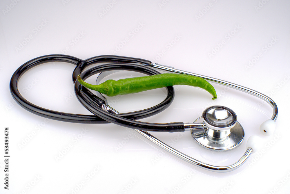 A stethoscope with a green chili A stethoscope with a green chili