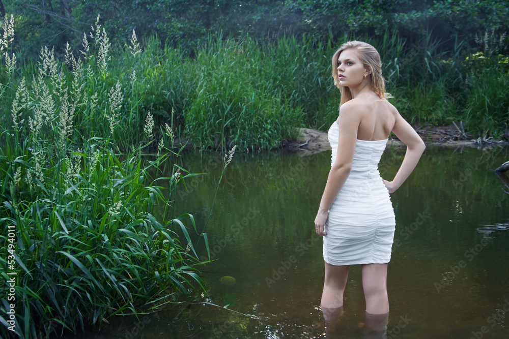 Fototapeta premium Portrait of beautiful young girl outdoors in summer