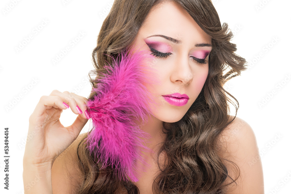 Glamorous young woman with pink feather