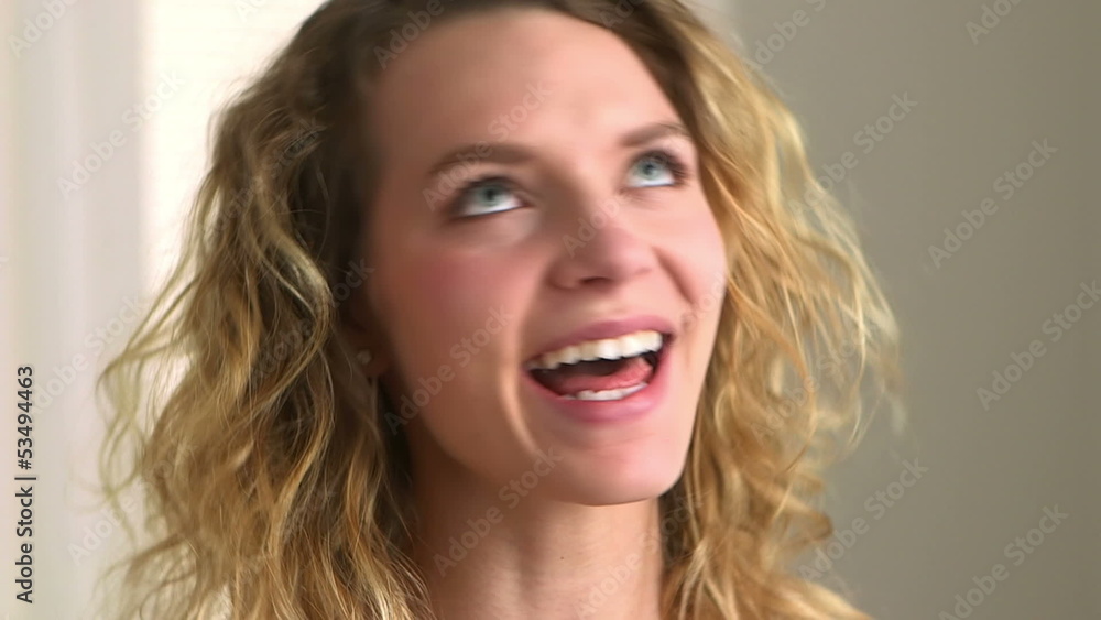 Close-up of a happy blonde woman with curly hair Close-up of a happy blonde woman with curly hair