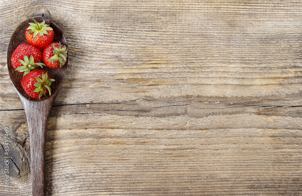 Strawberries on wooden spoon. Copy space. Strawberries on wooden spoon. Copy space.