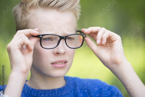 Confident teenage boy with glasses outdoor