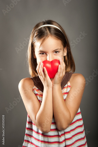 little girl with red heart