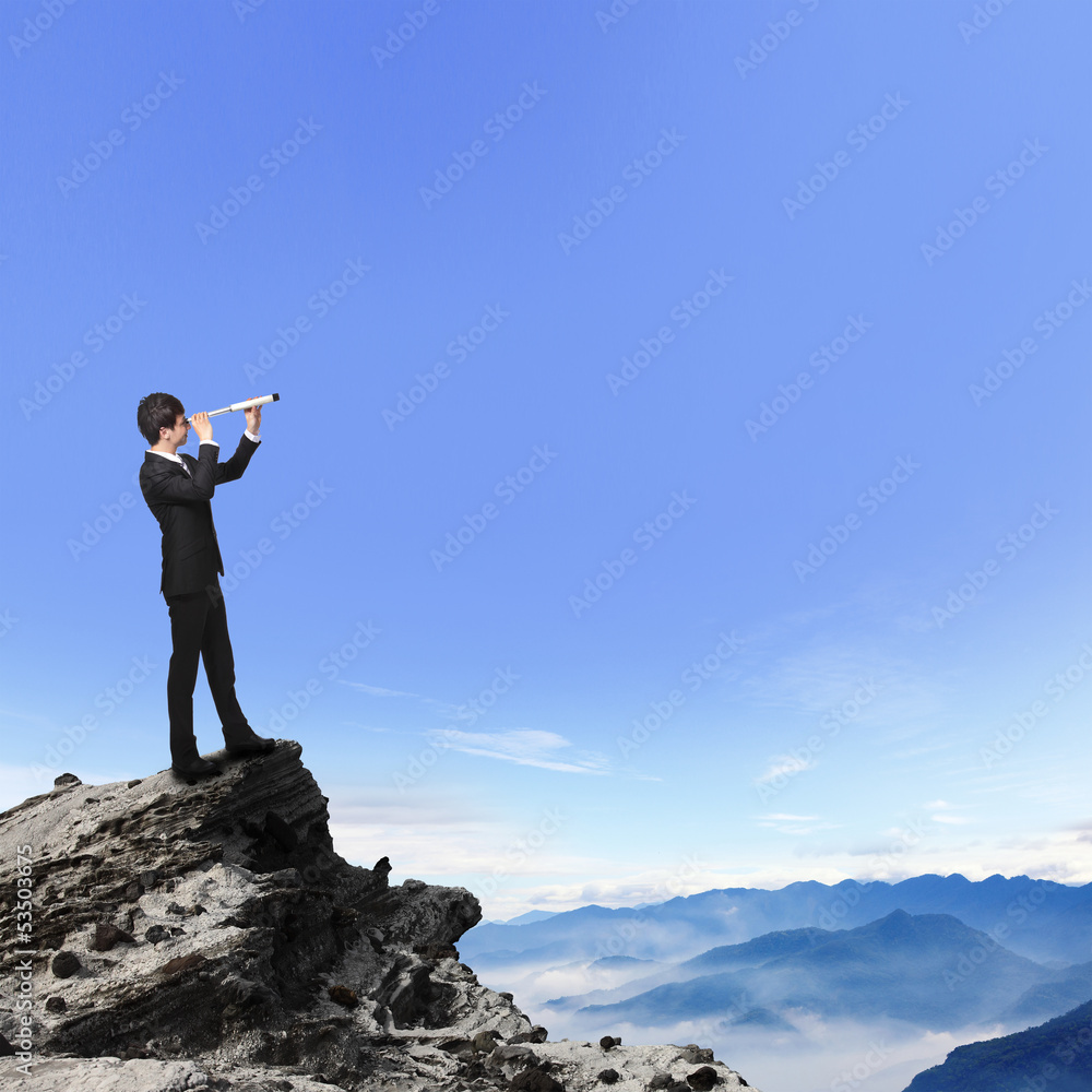 business man looks through telescope on mountain business man looks through telescope on mountain