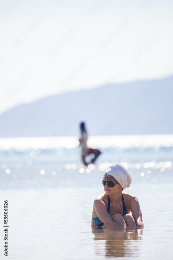 Fototapeta premium Woman in water trying to cool down