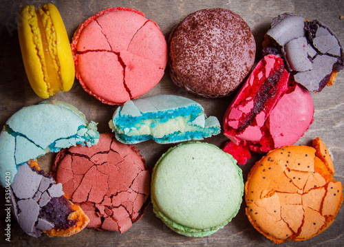 Colorful french macaroons on dark wooden background