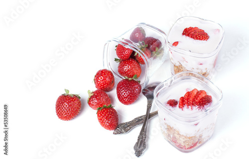 muesli, strawberries and yogurt on a white background