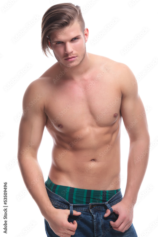 topless fashion man pulls on his pants topless fashion man pulls on his pants