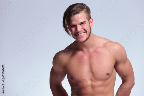 topless young man shows a big smile
