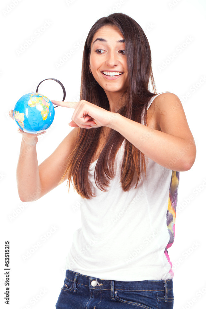Pretty female holding a globe and using a magnifying glass while Pretty female holding a globe and using a magnifying glass while