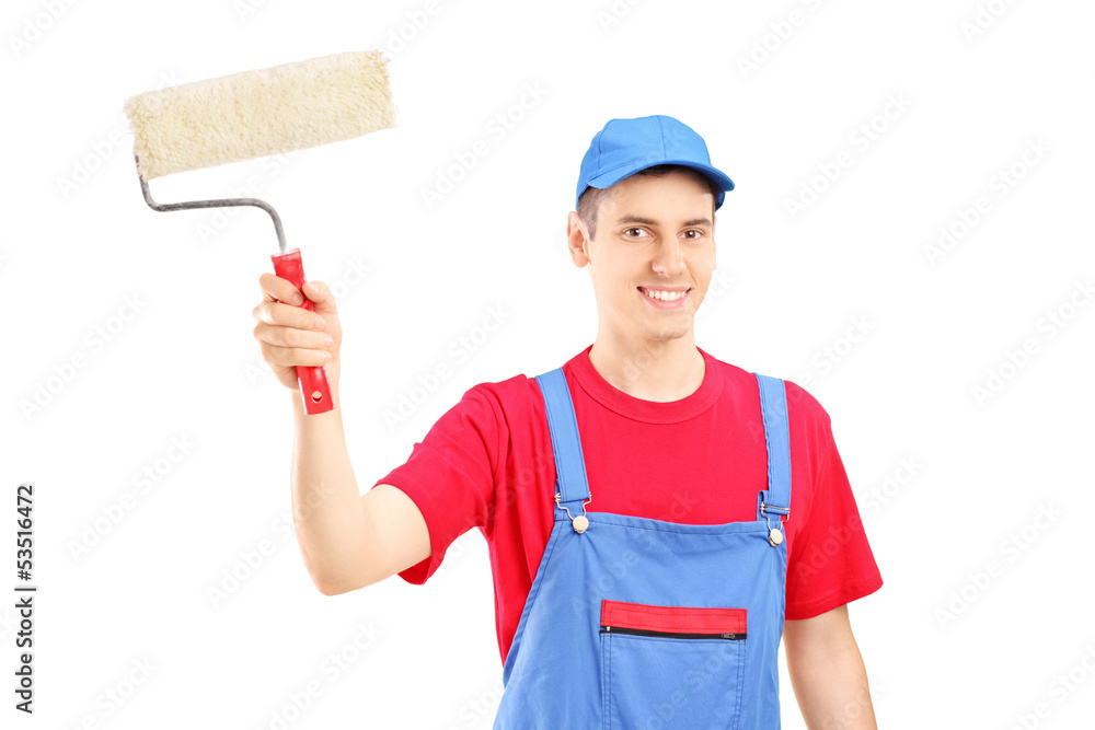 Smiling painter in a uniform holding a roller Smiling painter in a uniform holding a roller