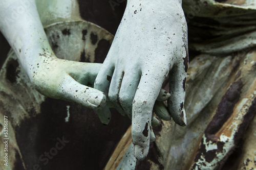 old bronze statue two people holding hands