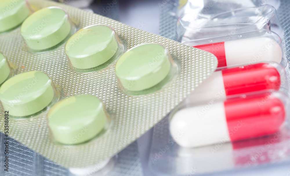 Pills of many shapes and colors grouped together Pills of many shapes and colors grouped together