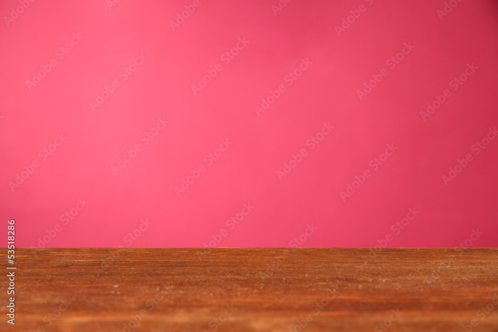 Wooden table on pink background Wooden table on pink background