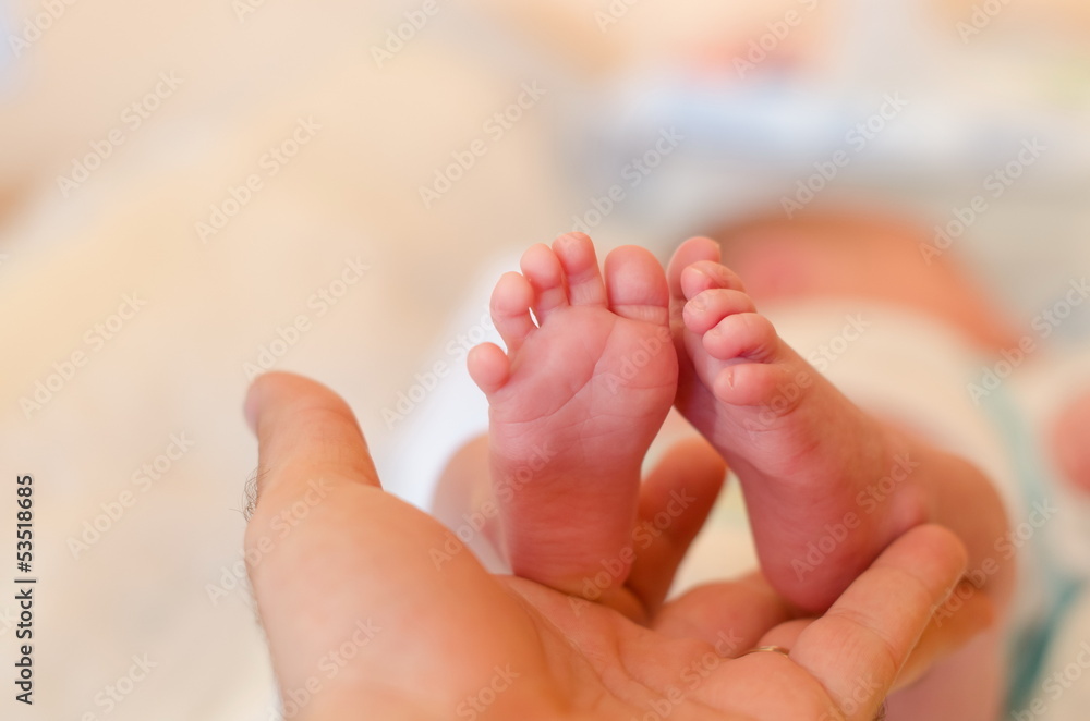 Father is holding his child's foot Father is holding his child's foot