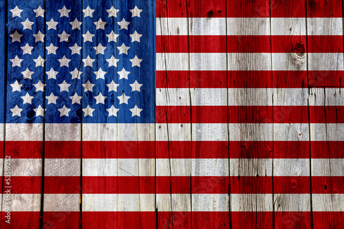 Old Painted American Flag on Dark Wooden Fence