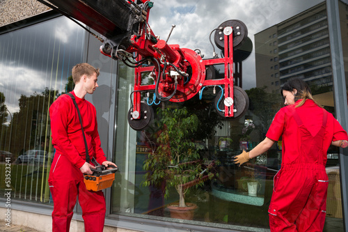 Glazier operating glass installation crane