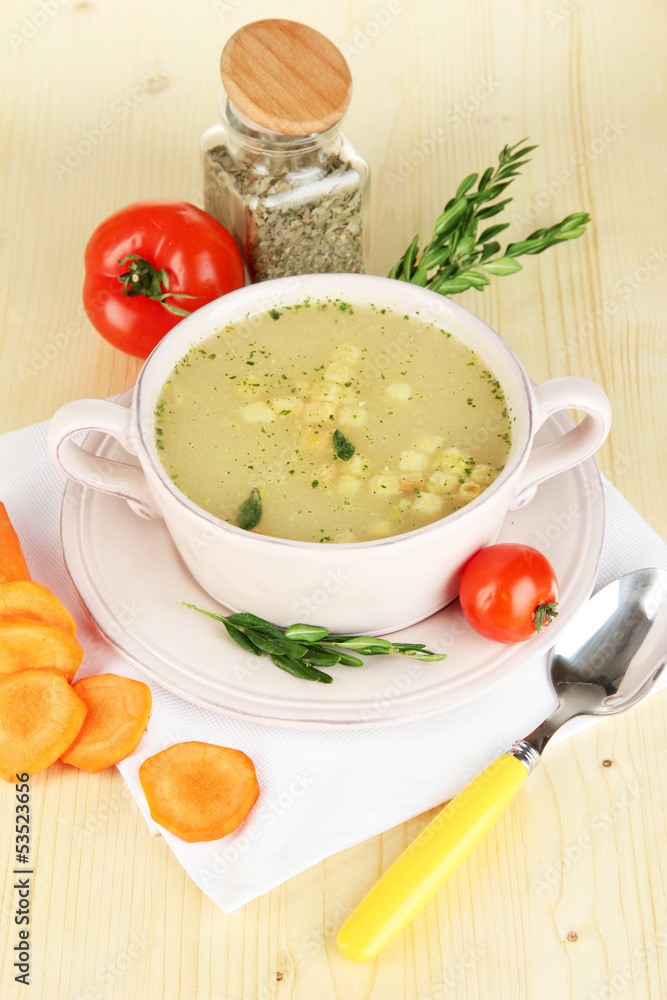 Nourishing soup in pink pan with ingredients Nourishing soup in pink pan with ingredients